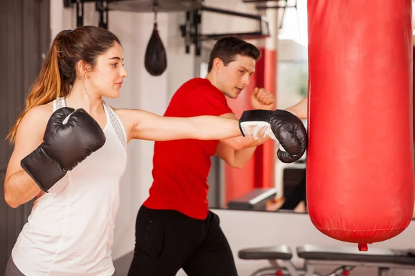 Woman with boxing gloves practicing