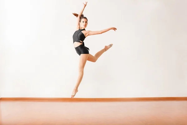 Hispanic dancer practicing  jump