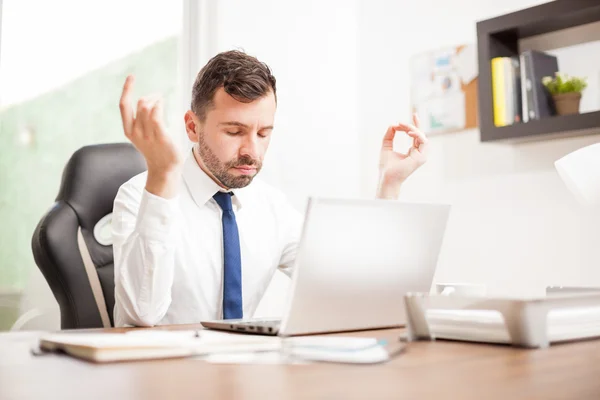 Businessman practicing some breathing exercises