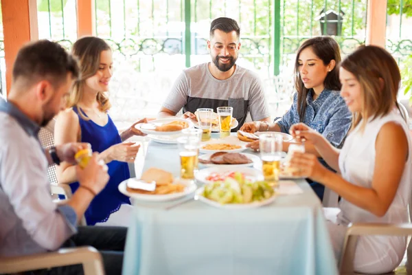 Friends eating hamburgers outdoors