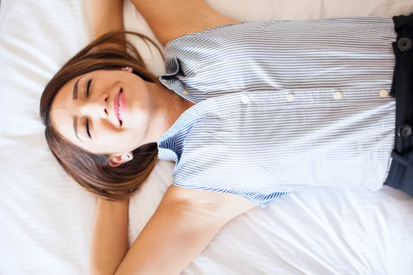 young businesswoman lying on a bed