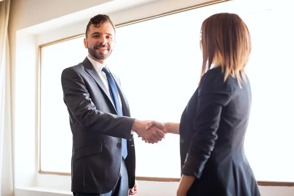 Businessman giving a handshake to client