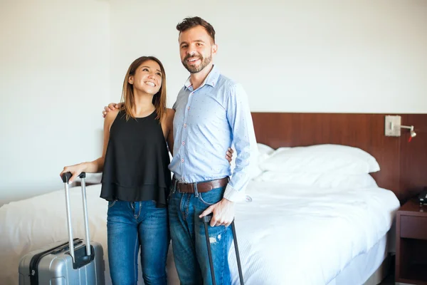 Couple in love carrying their luggage