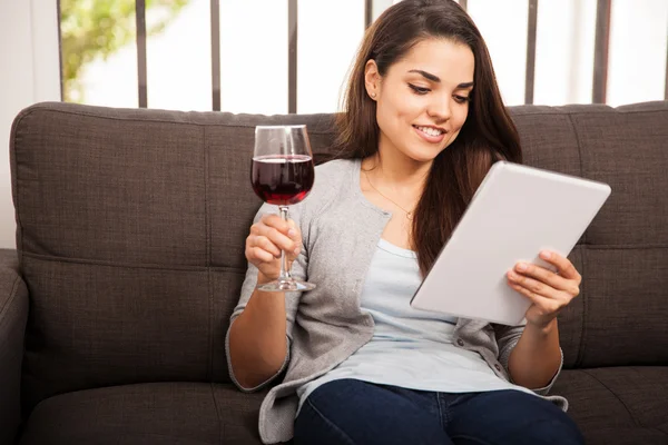 Woman with tablet and wine glass