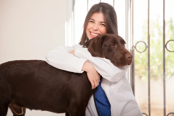 Veterinarian hugging a dog
