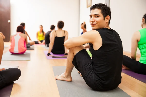 Man looking back during a yoga class