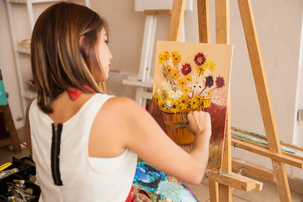 Female artist painting some flowers