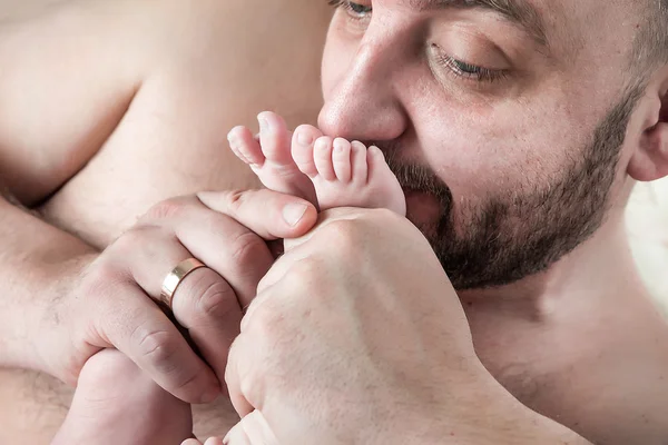 Father kisses the feet