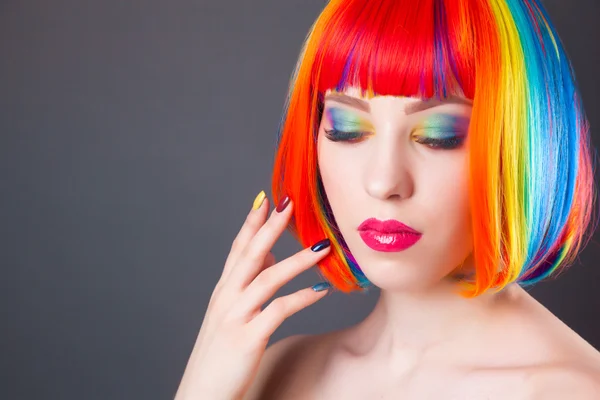 Beautiful woman wearing colorful wig