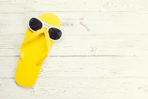 Yellow flip flop and sunglasses