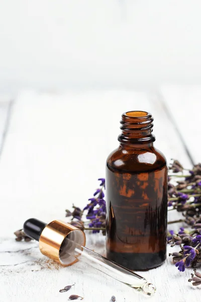 Dry lavender and oil on a white wooden table