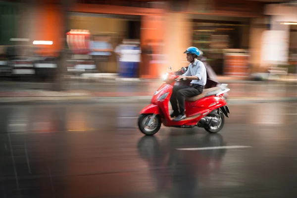 Man riding scooter in Vietnam, Asia.