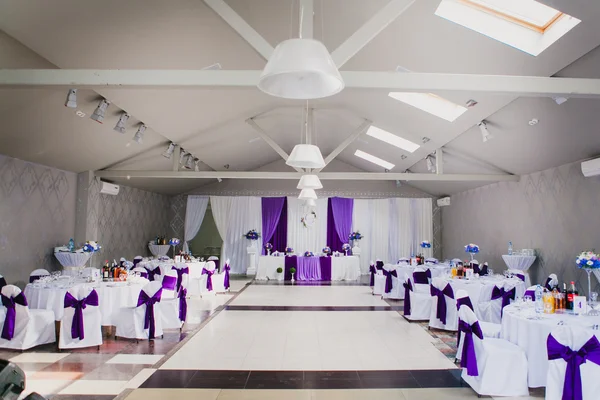Elegant restaurant room before wedding party, horizontal. Purple, violet tableware