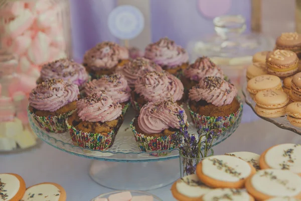 Closeup of cupcakes with lavanda flowers at wedding party