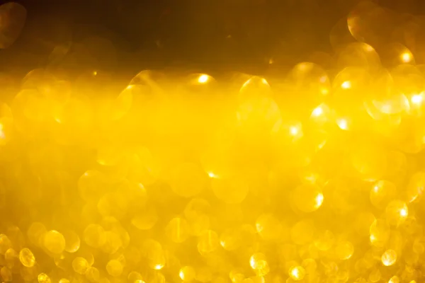 Golden glitter christmas abstract background. Shiny golden lights