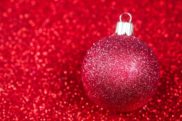 Christmas decorative ball on glitter bokeh background.
