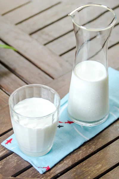 Milk jug with milk glass