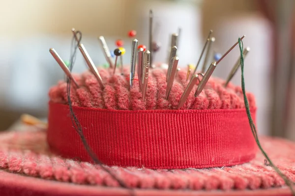 Pincushion with lot of needles and pins for sewing