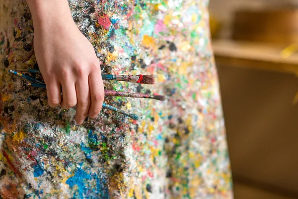 Closeup of female artist hand holding paintbrush