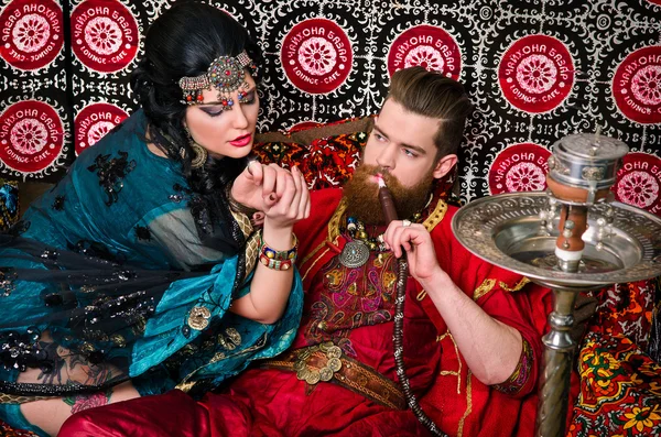 Woman and man in oriental costumes