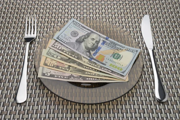 Dollar Bills on a plate with fork and knife