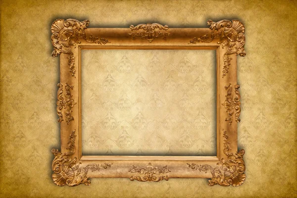 Gold baroque frame on a golden damask Victorian wallpaper