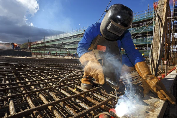 Construction worker working with metal rebar