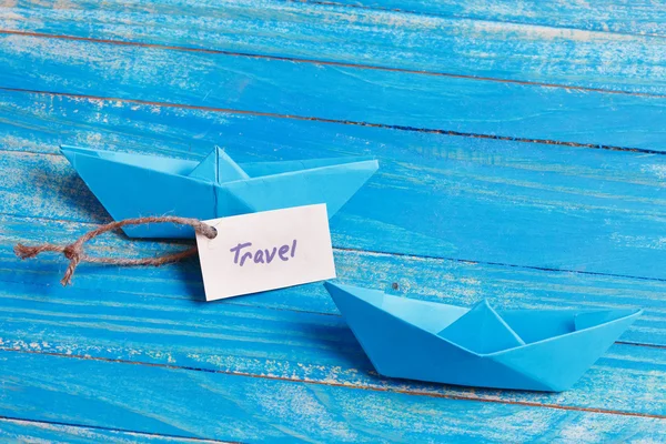 Paper Boat with a sign Travel - travel concept