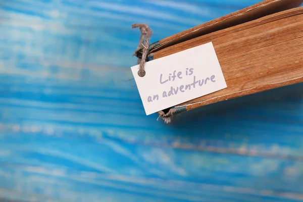 Life is adventure sign on old book - vintage style