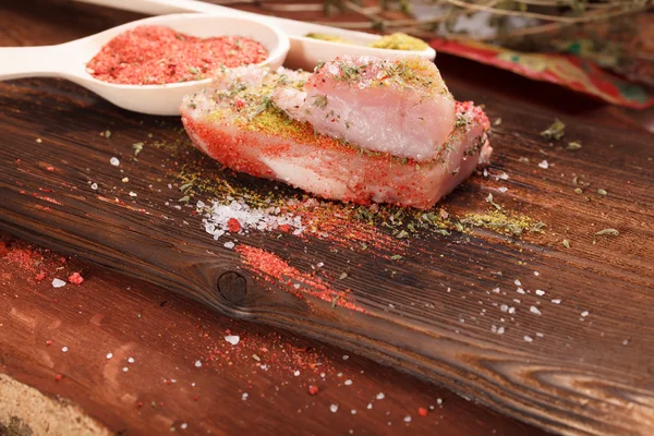 Raw juicy meat steak on dark wooden background