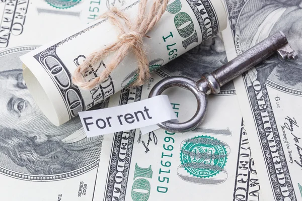 Money and business idea, The dollar bills tied with a rope, with a sign on key fob - For rent