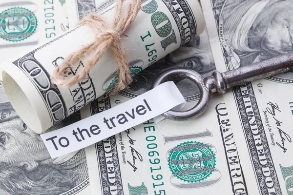 Money and business idea, The dollar bills tied with a rope, with a sign on key fob- To the Travel