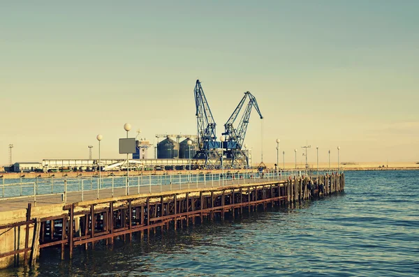 Commercial docks at sunset with a boat and cranes ,selective focus, Balchik, Bulgaria