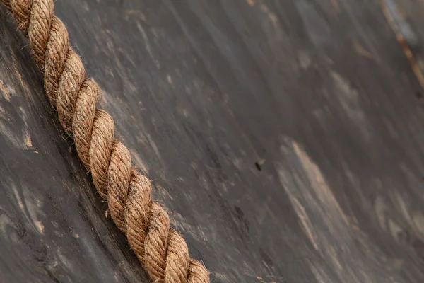 Thick Rope Lies Against Wooden Wall At Extreme Obstacle Course