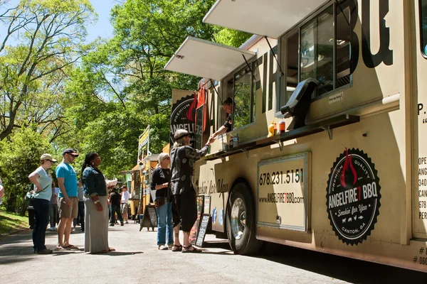 People Stand In Line To Buy Meals From Food Truck