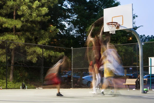 Young Men Motion Blur Playing Pickup Basketball Game At Park