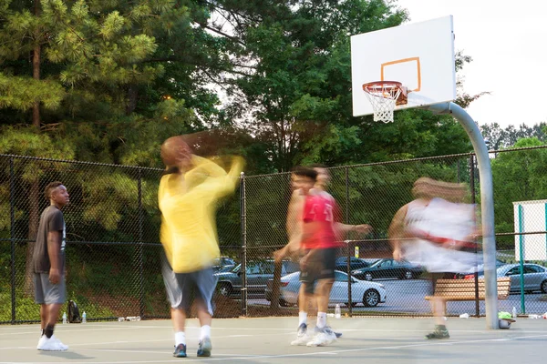 Motion Blur Of Men Playing Pickup Basketball Game In Park