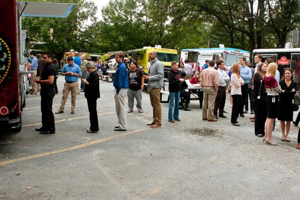 Customers Wait In Line To Order Meals From Food Trucks