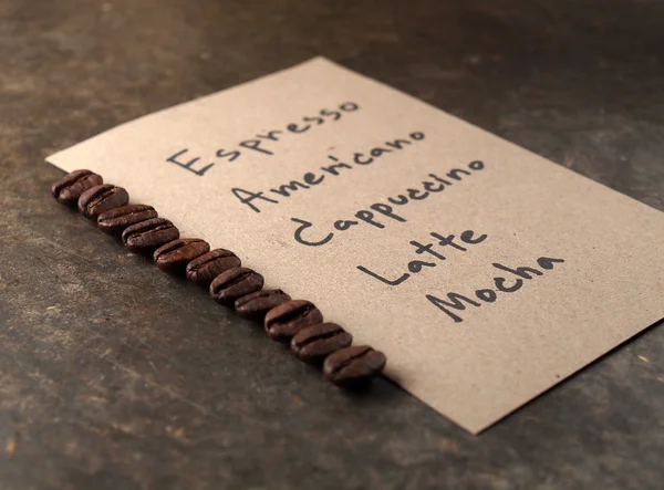 Coffee crop beans with paper on wood texture background