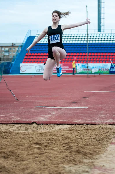 Girl performs a long jump