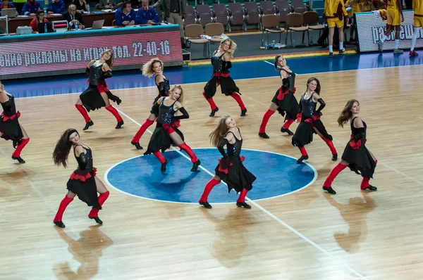 Girls cheerleading appear on basketball parquet