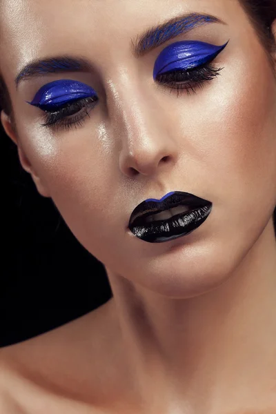 Portrait of woman with blue fashion make up