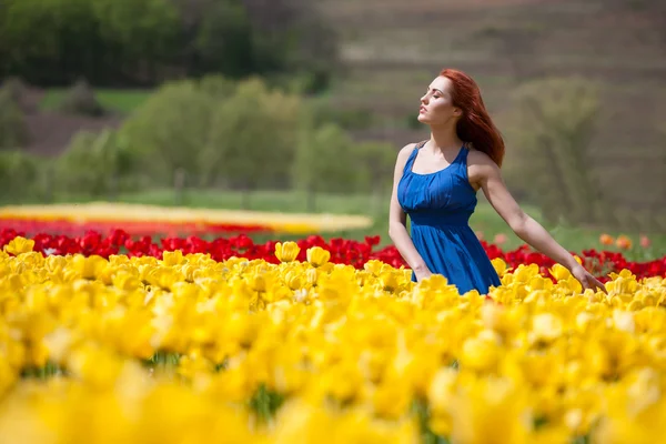 Dreamy woman in tulip field