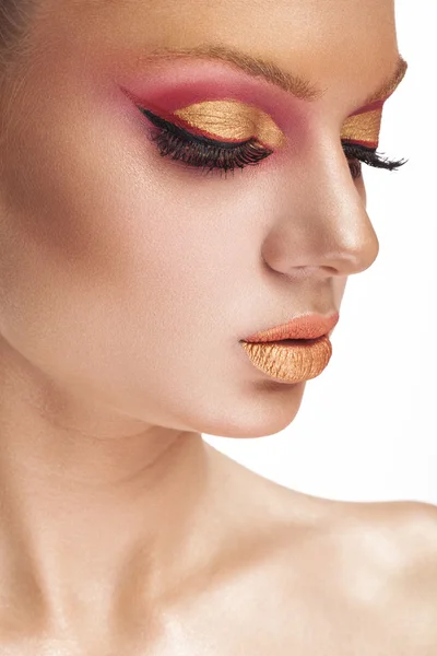 Girl with gold and red make up on white background