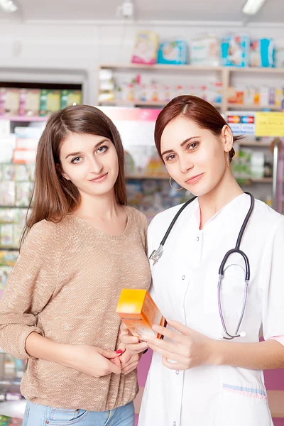 Woman doctor showing antibiotic to buyer