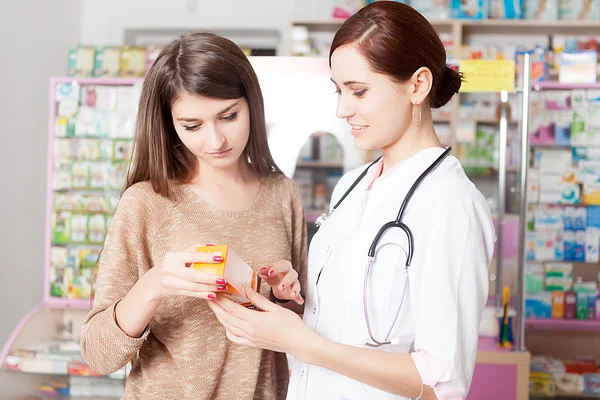 Pharmacist showing product to client