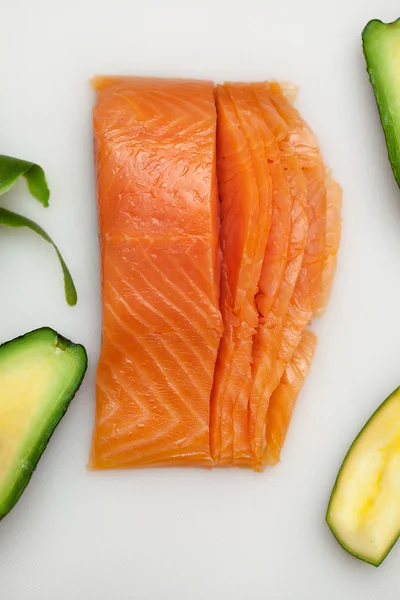 Salmon fish for sushi preparation on white table