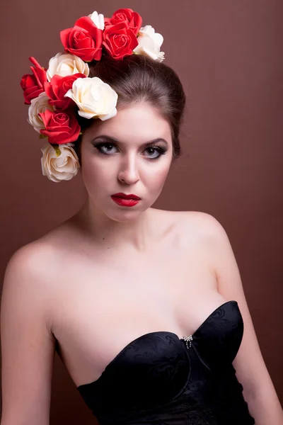 Girl with flowers in her head on brown background