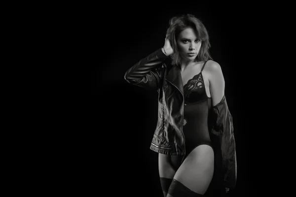Sexy woman in body and leather jacket in black and white image