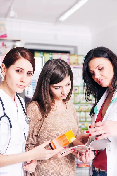 Two female doctors explaining a product to client